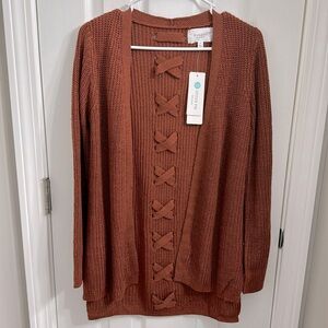New with tags, Pinque women’s sweater/cardigan in size small.